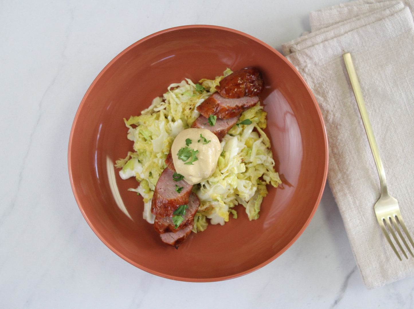 Brats Over Seasoned Cabbage With Mustard Sauce